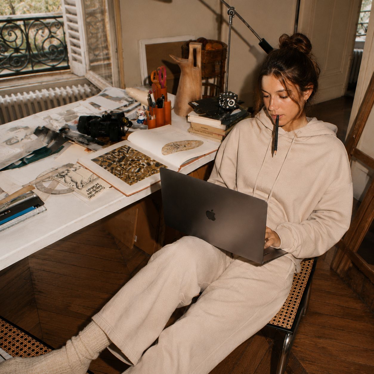 A business owner working alone at her desk in the evening